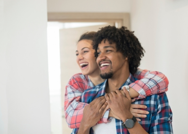 Couple hugging and smiling in new home